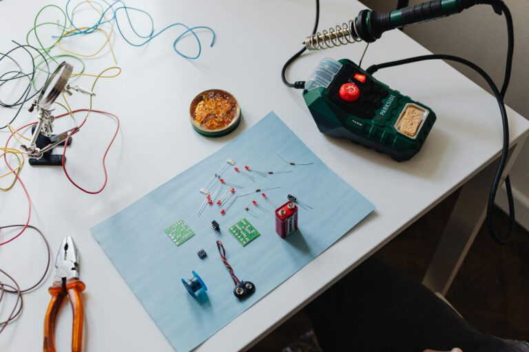 A workspace with a soldering station, tools, and electronic components ready for repair.